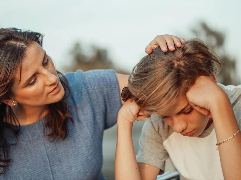 mother comforting teen son