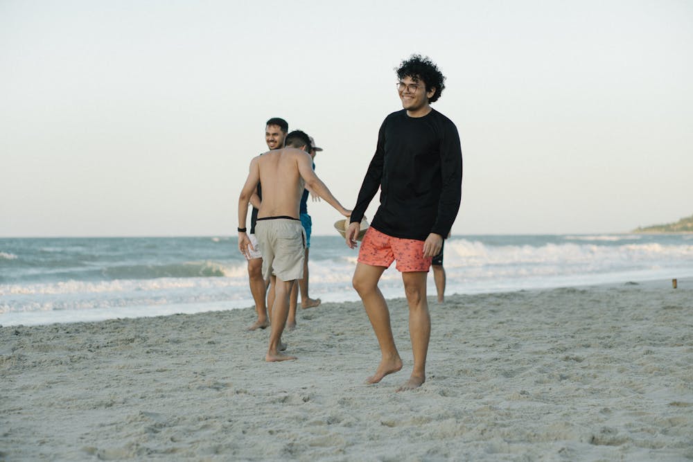 Teenage boys at beach walking