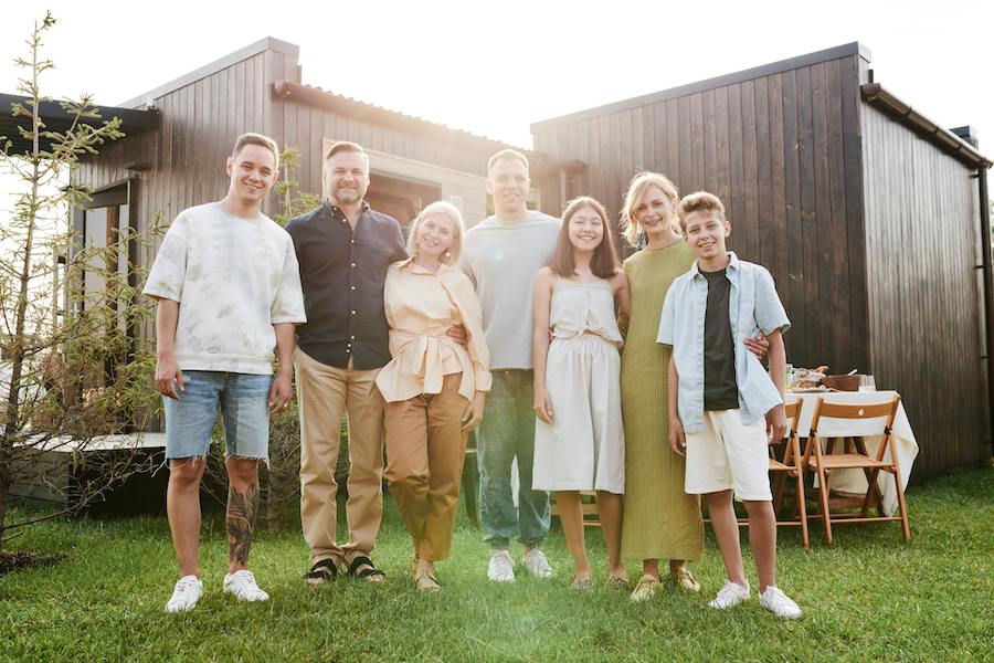 family with teenage children smiling together