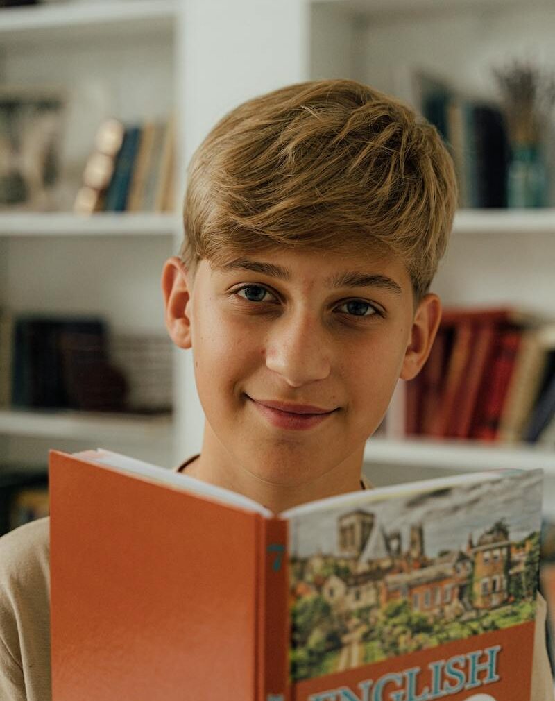 care concepts therapy teen boy reading text book smiling-min teen boy reading text book smiling