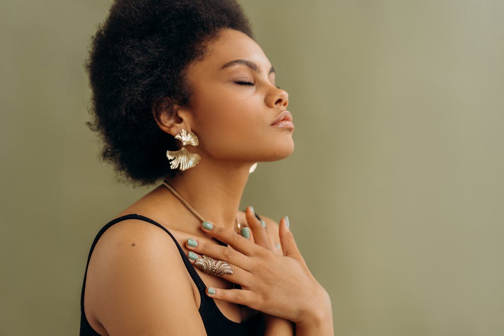 young woman with eyes closed and hands over chest