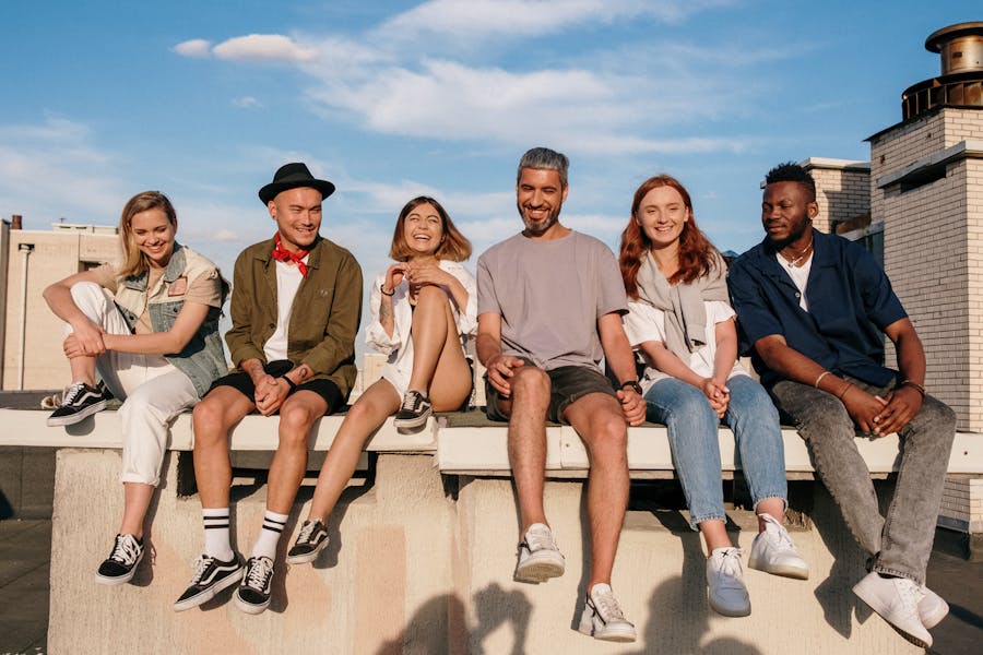 Care Concepts therapy young adults laughing and sitting on a ledge-min