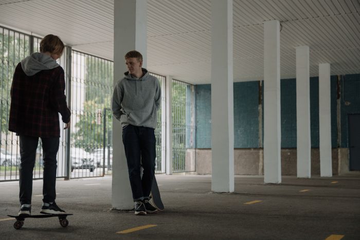 care concepts therapy teen boys skate boarding in parking garage